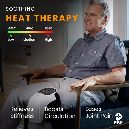 A man comfortably seated in a chair, smiling, with a knee massager on his leg. Text overlay: "SOOTHING HEAT THERAPY. 40°C Low, 45°C Medium, 55°C High. Relieves Stiffness | Boosts Circulation | Eases Joint Pain."