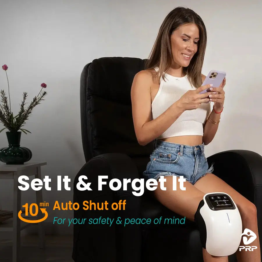 A woman sits in a recliner, looking at her phone, with a knee massager on her leg. Text overlay: "Set It & Forget It. 10 min Auto Shut off. For your safety & peace of mind."